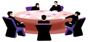 image of persons discussing across the table.