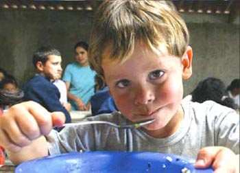 Child sitting at table eating