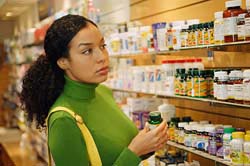 picture of woman shopping for vitamins in a store.