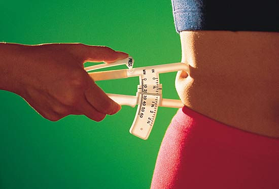 Image of a BMI test being done to the waist area.