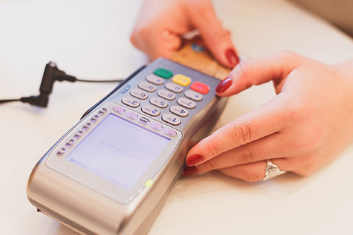 person using a card swipe machine