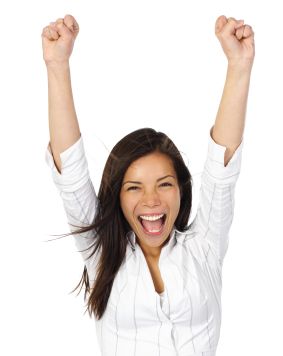 woman in a white shirt with an excited expression on her face, mouth open, arms raised above her head, and her hands in fists