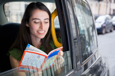 Girl reading travel brochure