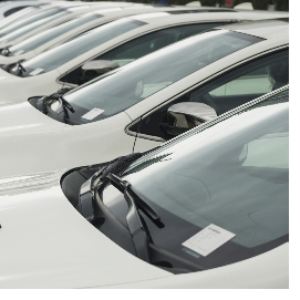 "Image of a line of compact cars for sale"