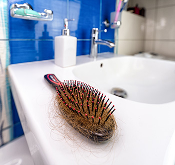 A hairbrush full of hair.