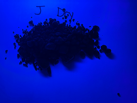 Soil under UV light labelled J - Dry