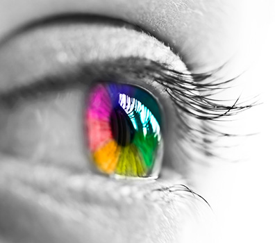 A human eye. The photo is in black and white, excpet for the iris, which is colored like a rainbow.