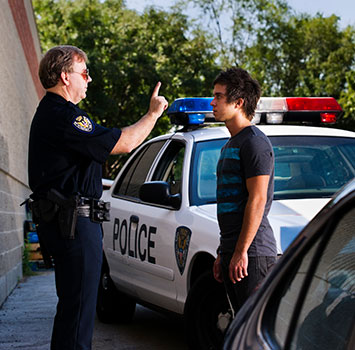 A police officer giving a man a field sobriety test.