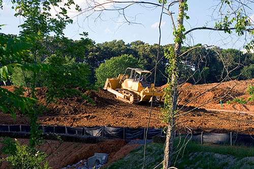 a bulldozer on a dirt mound