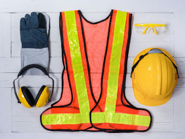 safety vest, gloves, hearing protection, goggles, and a hard hat