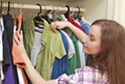 woman looking in closet for clothes