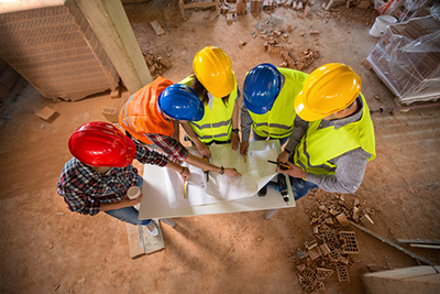 construction workers looking at blueprints