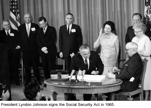 President Lyndon Johnson signs the Social Security Act.