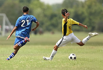 soccer player kicking a soccer ball