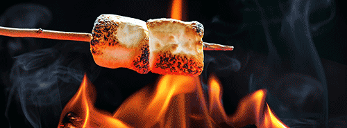 marshmellows on stick roasting over fire