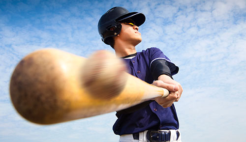 baseball player hitting a ball with a bat