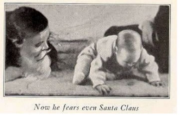 "Image of a baby looking away from Santa Claus"