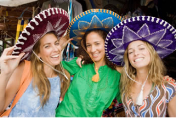 "Image of three young ladies all wearing colorful hats"