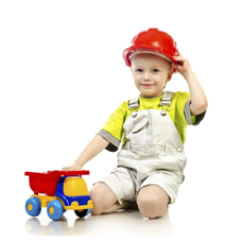 "Image of a young boy wearing a firehat and playing with a toy truck."