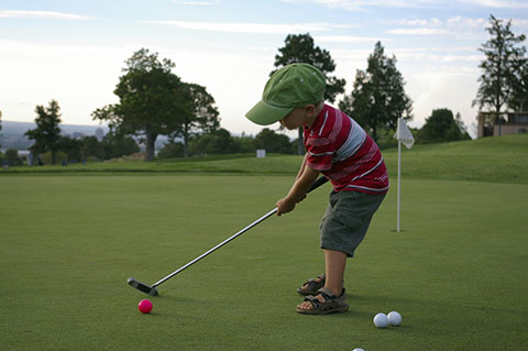 boy playing golf