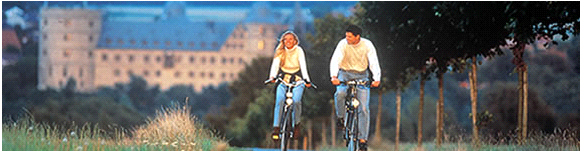 A man and a woman biking