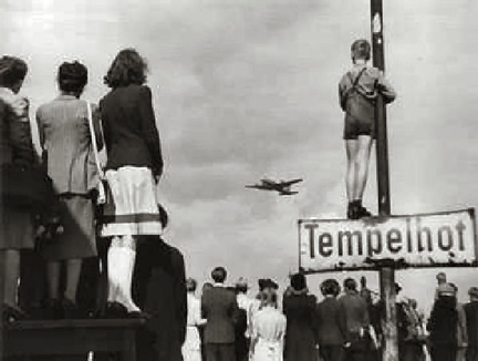 Berlin Civilians watching an airlift plane