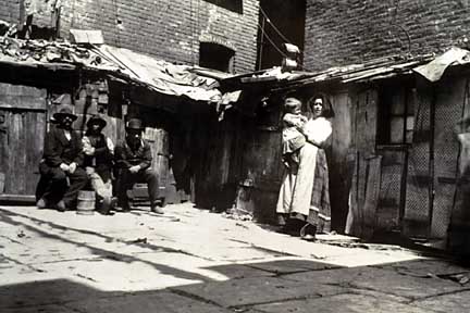 Immigrants in the courtyard of a New York City tenement
